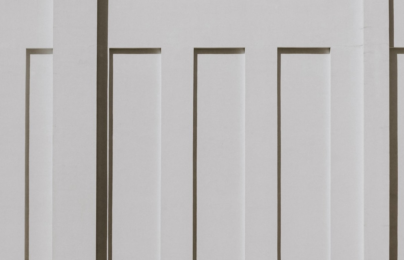 Fluted panel detail, vertical grooves catching strong side light