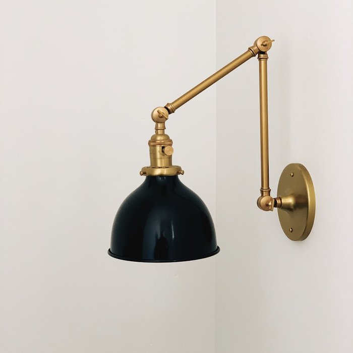 Brass wall sconce with black enamel shade